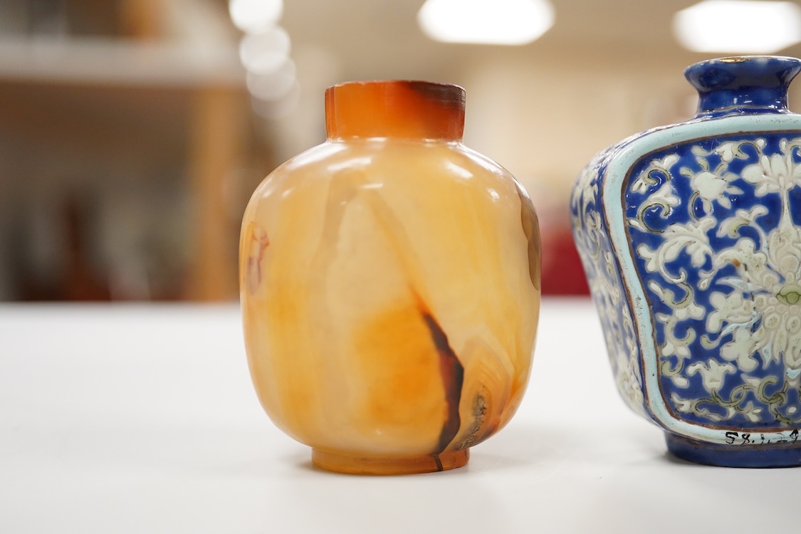 Three 19th century Chinese agate snuff bottles and a porcelain snuff bottle, largest 6cm high (4)